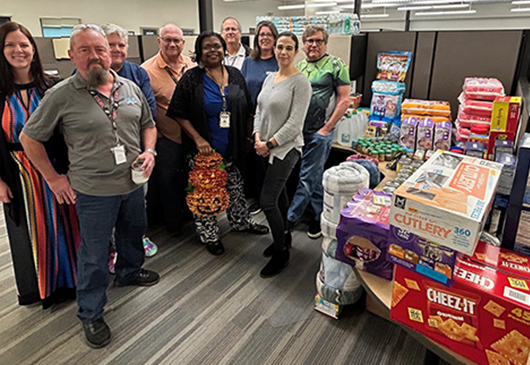 People with a table of collected donations.